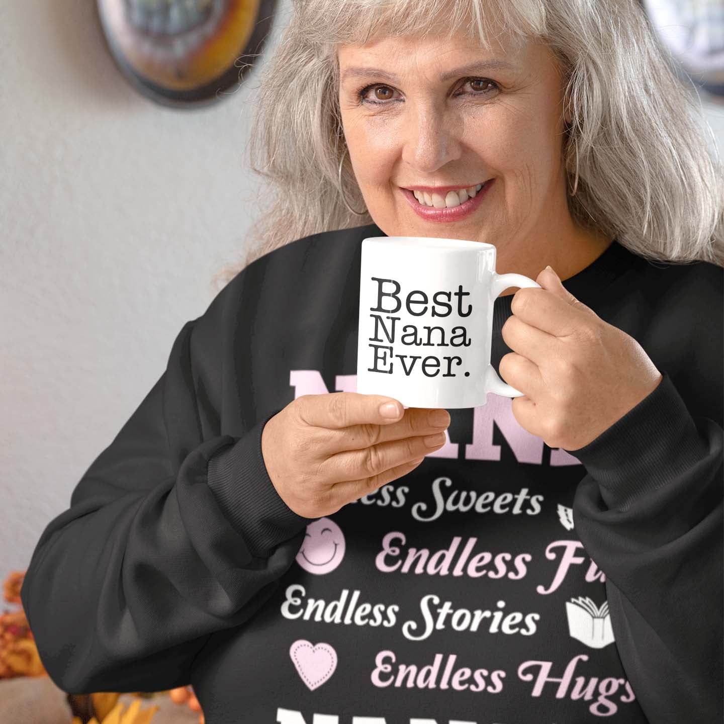 Grandma holds a mug with a funny caption and wears a sweatshirt for grandmothers